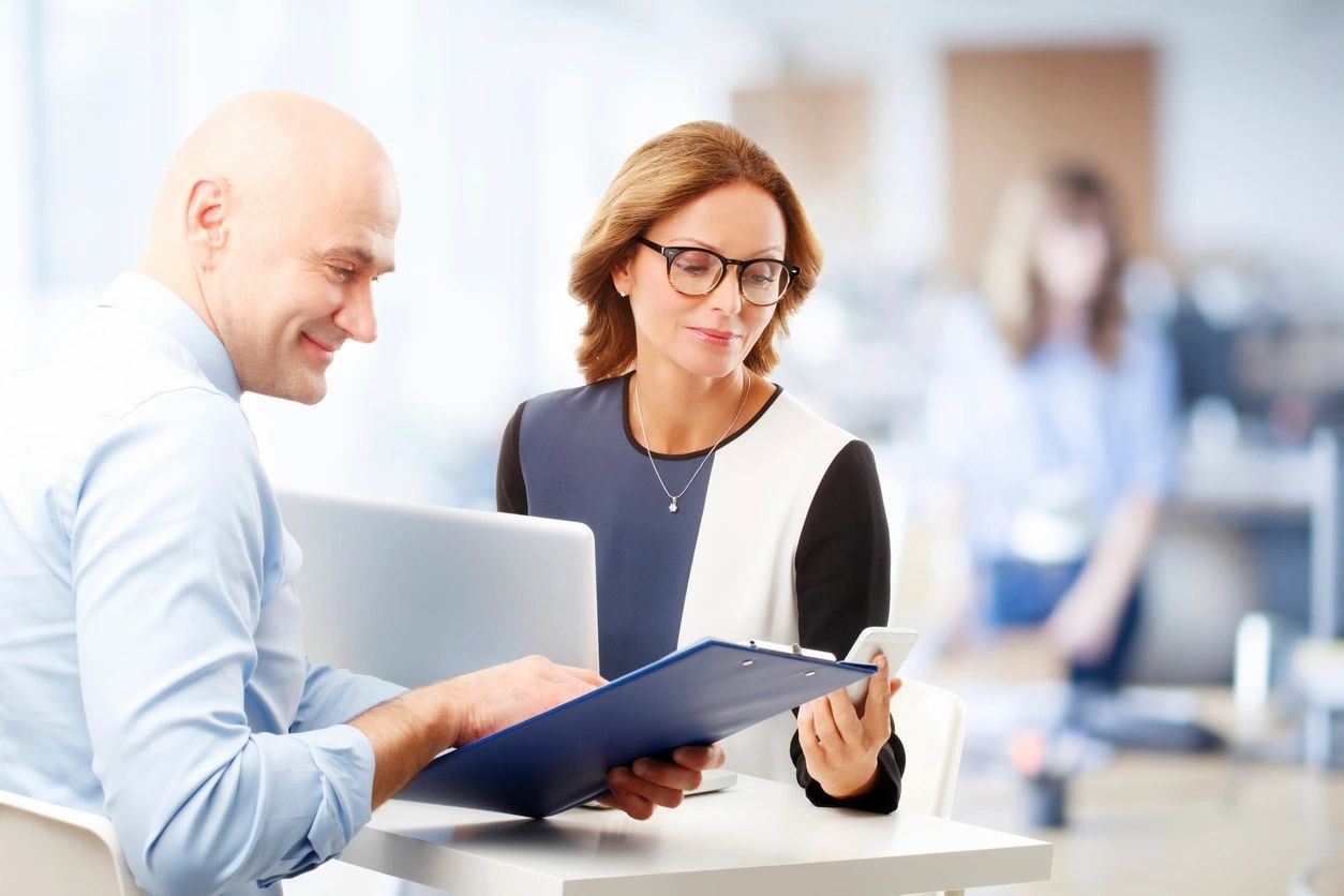 Consultants collaborating at a desk